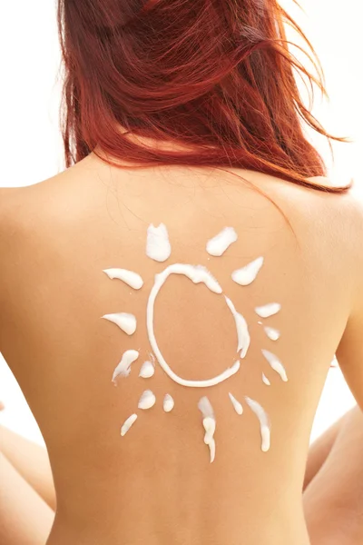 Žena s ve tvaru slunce sun cream — Stock fotografie