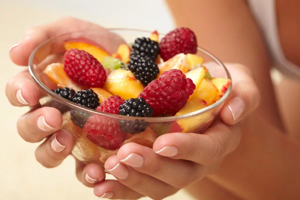 Fruit salad in the hands — Stock Photo, Image