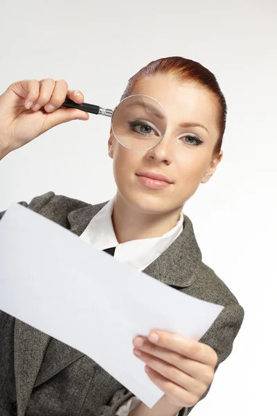 Woman holding a magnifying glass in the hand — Stock Photo, Image