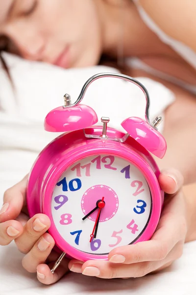 美しい女性の睡眠と目覚まし時計 ロイヤリティフリーのストック写真