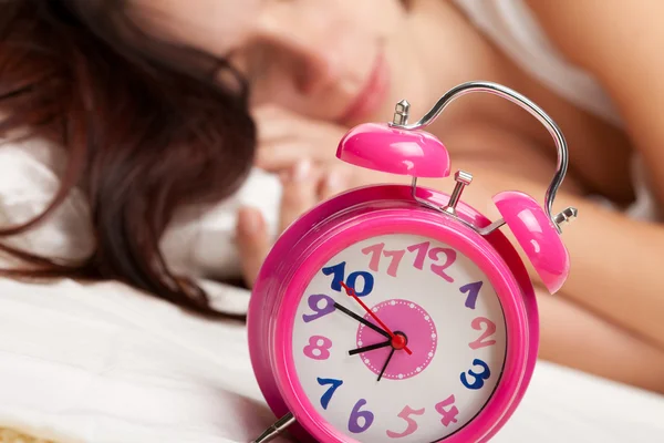 Beautiful woman and alarm clock Stock Picture