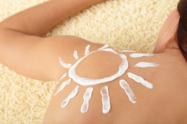 Woman with sun-shaped sun cream clipart