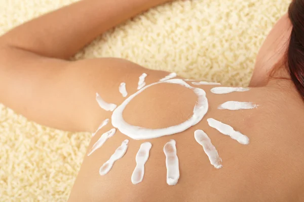 stock image Woman with sun-shaped sun cream