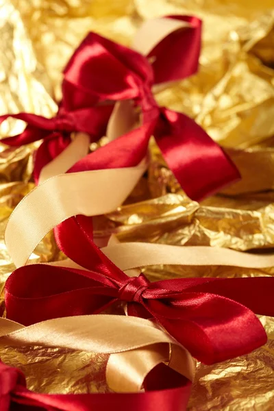 Satin ribbons on the gold background — Stock Photo, Image