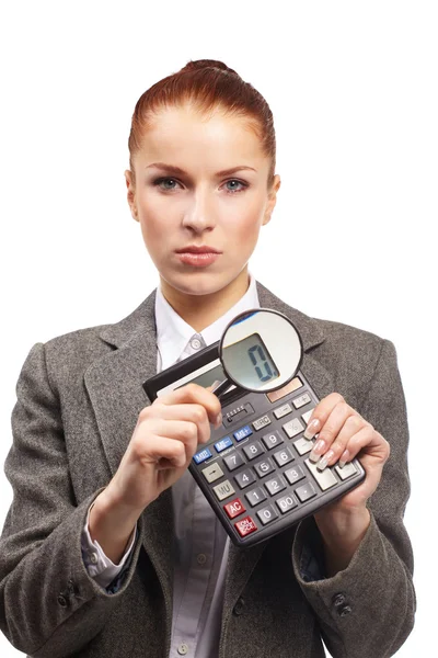Portrait of young businesswoman with calculator and magnifying glass — Stock Photo, Image