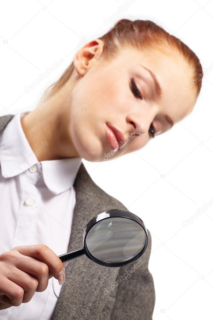 Portrait of young businesswoman with magnifying glass