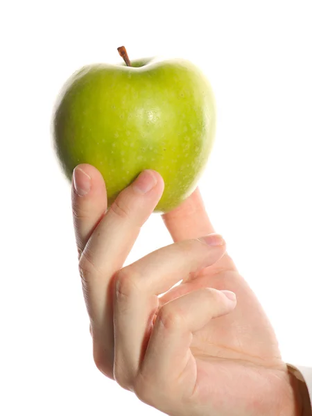 Grönt äpple i en hand — Stockfoto