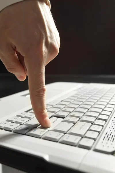 Μεγέθυνση του χέρι αγγίζει τα πλήκτρα του υπολογιστή κατά τη διάρκεια εργασιών — Φωτογραφία Αρχείου