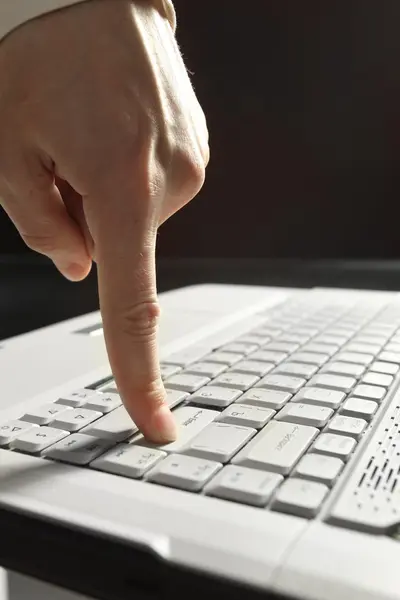 Close-up of hand touching computer keys during work — Stock Photo, Image