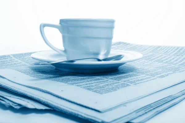 Cup coffee on a morning paper business news — Stock Photo, Image