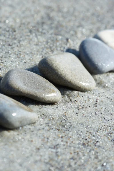 Stones on sand at the sea, a pebble — Stock Photo, Image