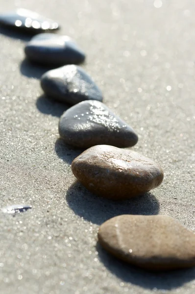 Stones on sand at the sea, a pebble — Stock Photo, Image