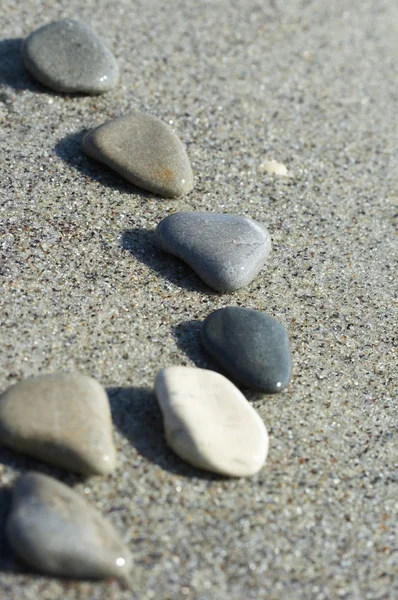 Pedras na areia no mar, um seixo — Fotografia de Stock