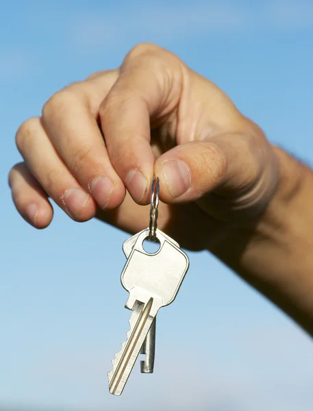 Hand keys in the blue skies Royalty Free Stock Images
