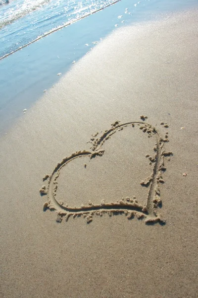Heart drawn on sand, seacoast Stock Photo