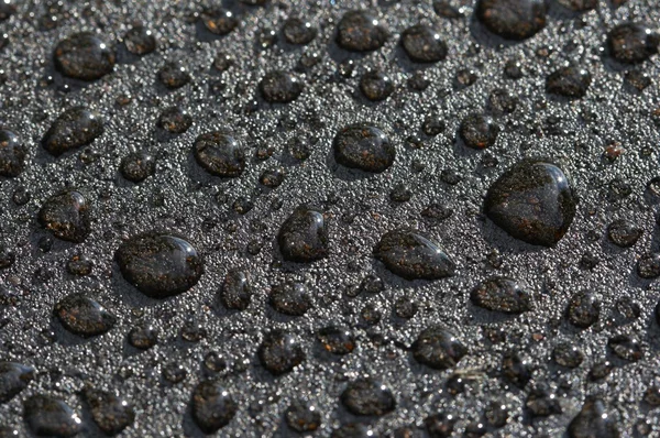 Gotas no asfalto fresco — Fotografia de Stock