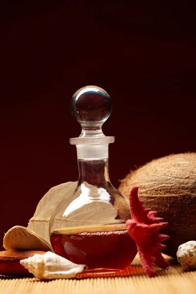 Still-life with a bottle and exotic subjects — Stock Photo, Image