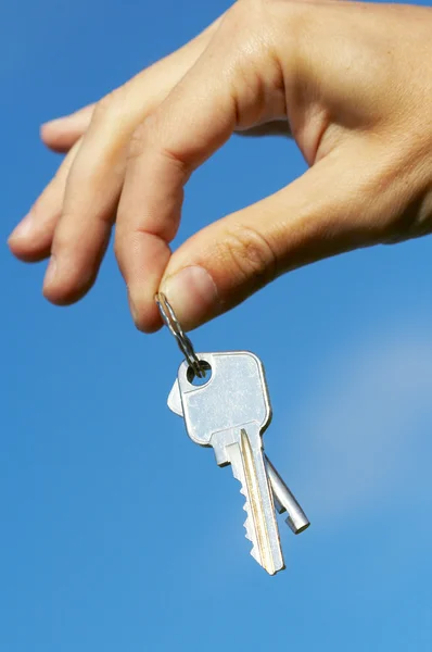 Hand keys in the blue skies Royalty Free Stock Photos