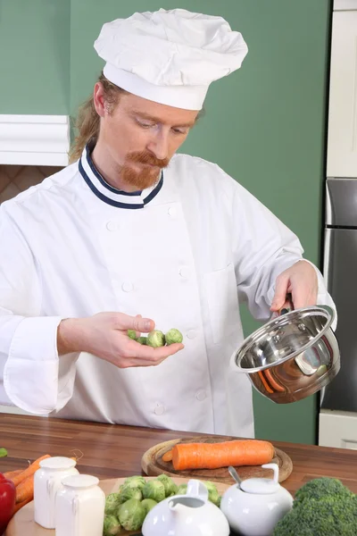 Young Chef with Brussels sprouts — Stock Photo, Image