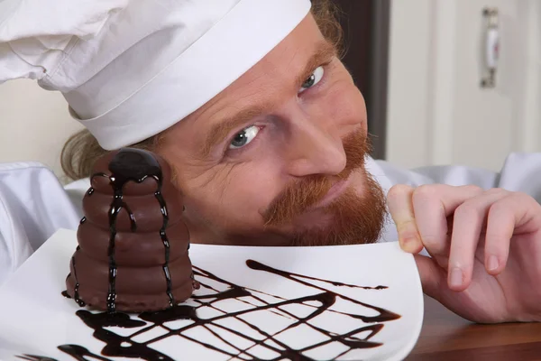 stock image Young chef with piece of cake