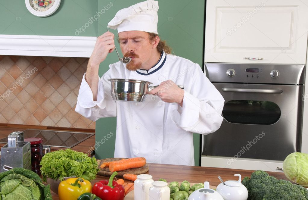 Young Chef tasting food with a tablespoon