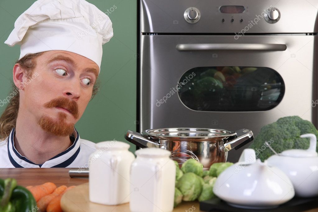 Funny young chef strange looking at pot — Stock Photo © vladacanon 9059710