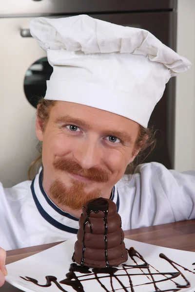 stock image Young chef with piece of cake