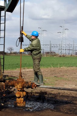 Oil worker check oil pump clipart