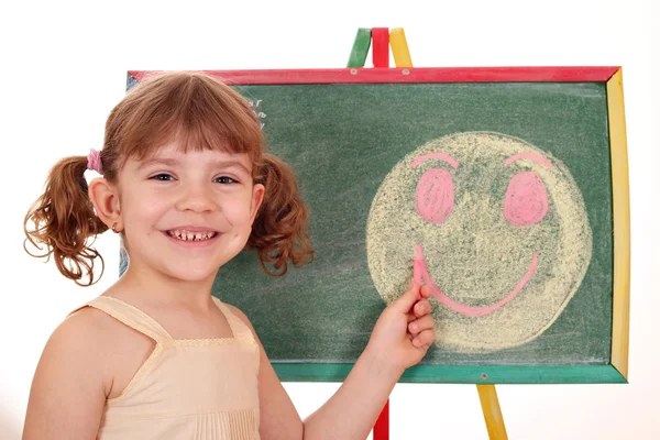 Happy little girl drawing smiley face — Stock Photo, Image