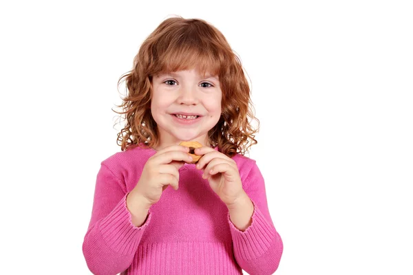 Söt liten flicka äter cookie — Stockfoto