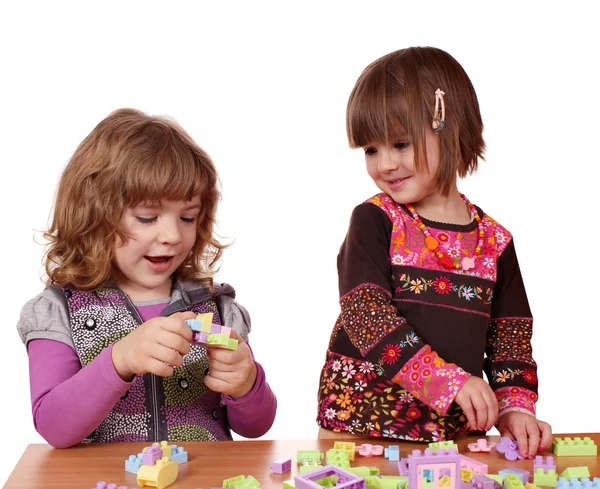 Little girls play with toy blocks — Stock Photo, Image