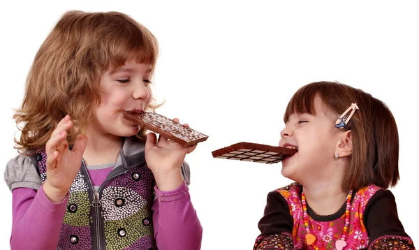 Duas meninas comendo chocolate — Fotografia de Stock