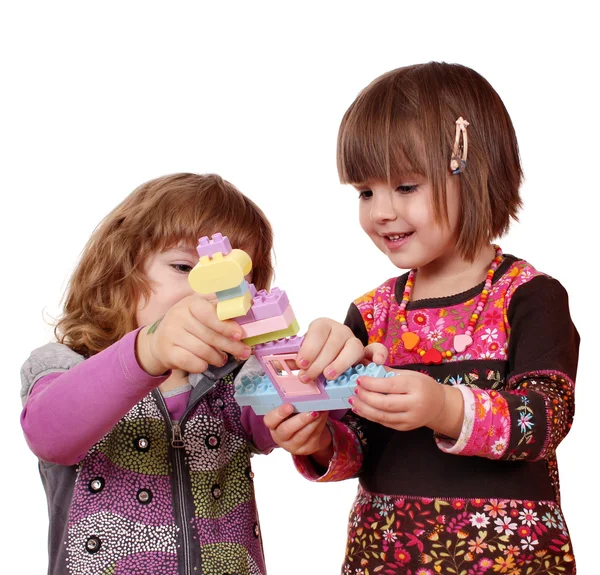 Las niñas juegan y se divierten con bloques de juguetes —  Fotos de Stock
