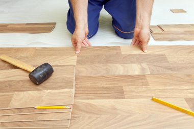 Installing wooden laminate flooring clipart