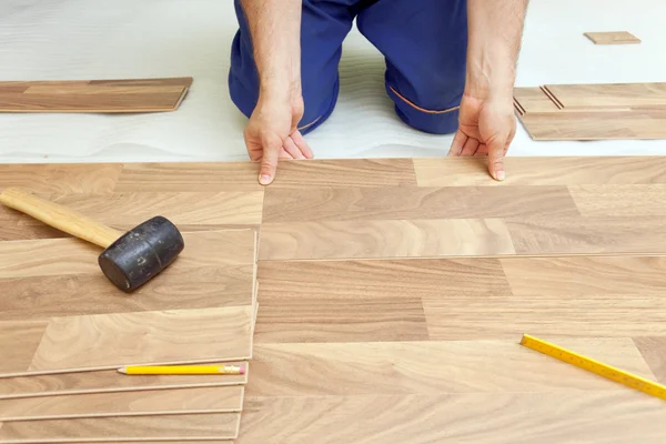 Installing wooden laminate flooring — Stock Photo, Image