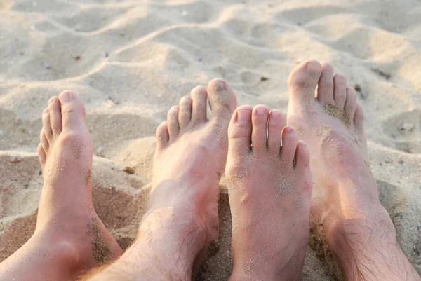 Legs on sandy beach — Stock Photo, Image