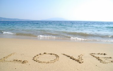 Love written on sand beach clipart