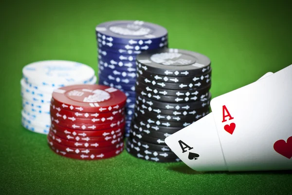 Poker table with two cards and gambling chips — Stock Photo, Image