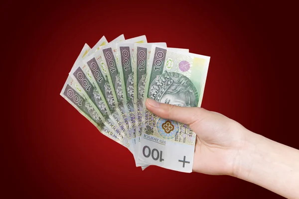 Polnisches Geld. roter Hintergrund. — Stockfoto