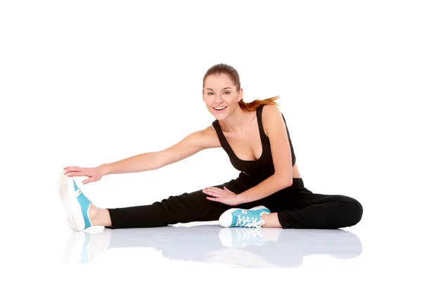 Beautiful fitness woman doing stretching exercise Royalty Free Stock Images