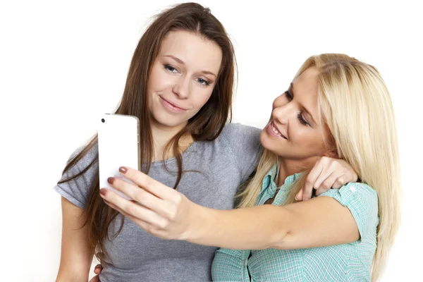 Two beautiful woman taking photo a smart phone — Stock Photo, Image