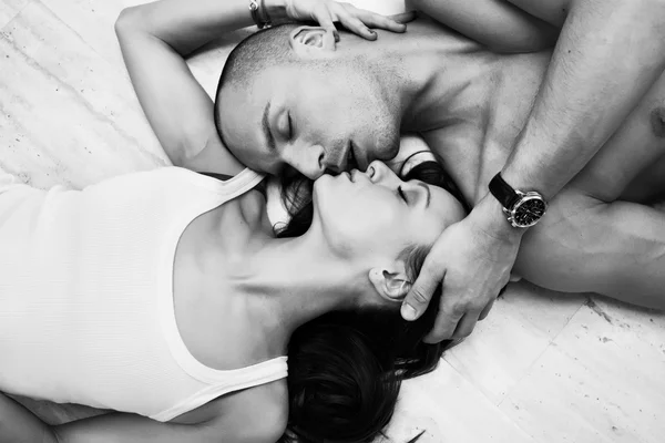 Joven pareja sonriente mirándose mientras están acostados en la cama. B) —  Fotos de Stock