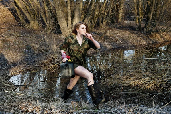 Military woman running in the forest