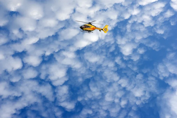 stock image Red helicopter on blue sky