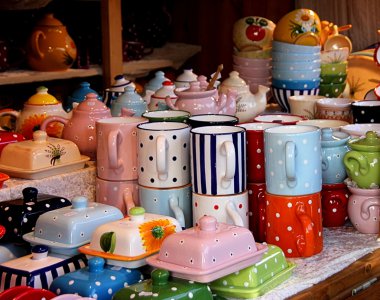 Colourful ceramic tableware in a market stall clipart