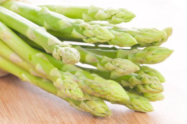 Asparagus bundle on wooden background clipart