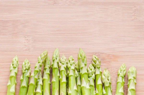 Asparagus bundle on wooden background — Stock Photo, Image
