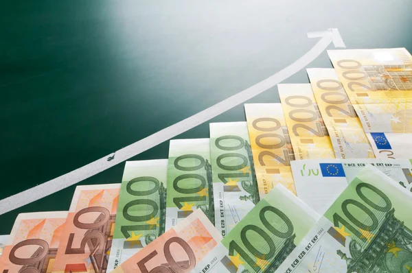 Euro banknotes and growing arrow — Stock Photo, Image