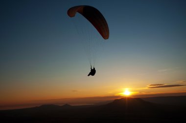 Paraglider in sunset clipart