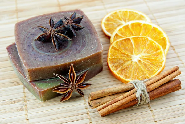 Hand-made soap with orange and cinnamon sticks — Stock Photo, Image